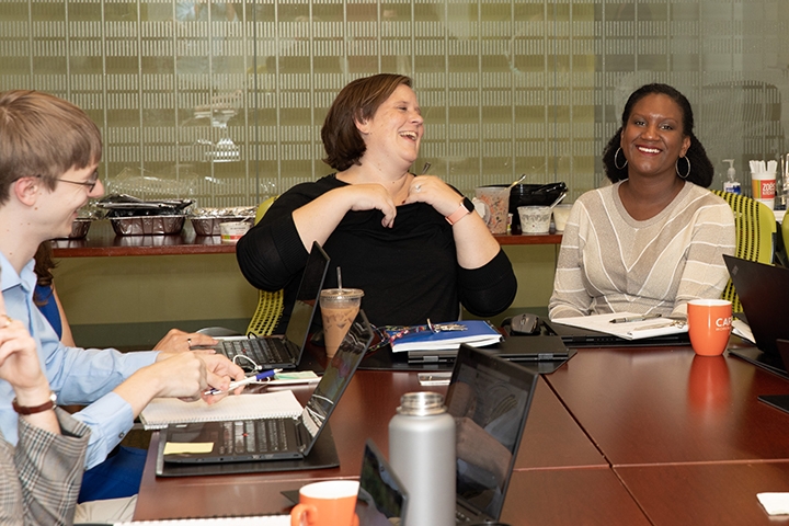 edCount team laughing at conference table